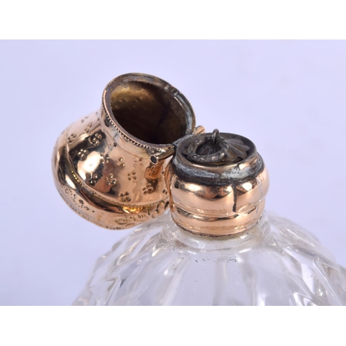 1147 - A GOLD TOPPED SCENT BOTTLE.  7.5cm x 4.4cm, weight 66.4g