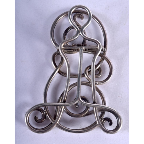 1157 - AN ORNATE WHITE M,ETAL PAPERCLIP.  8.3cm x 6.2cm, weight 51.8g