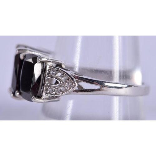 1240 - A SILVER RING INSET WITH BLACK STONES.  Stamped 925, size R/S, weight 4.8g