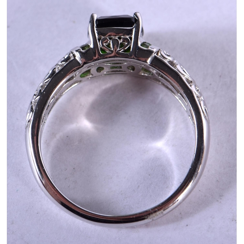 1244 - A SILVER RING INSET WITH A GREEN GEM.  Size R/S, weight 44g