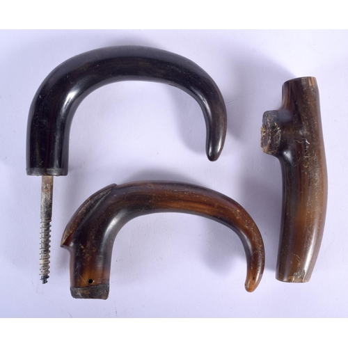 185 - A 19TH CENTURY MIDDLE EASTERN CARVED RHINOCEROS HORN HANDLE together with two other buffalo horn han... 