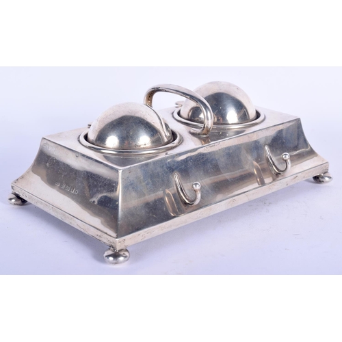 193 - AN EDWARDIAN SILVER RECTANGULAR DESK INK STAND with domed revolving top, supported upon bun feet. 89... 