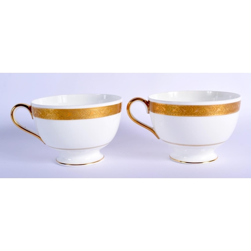 199 - 20th c. Minton pair of breakfast size teacup and saucers gilded with a crest Cup 7.5cm High, Saucer ... 