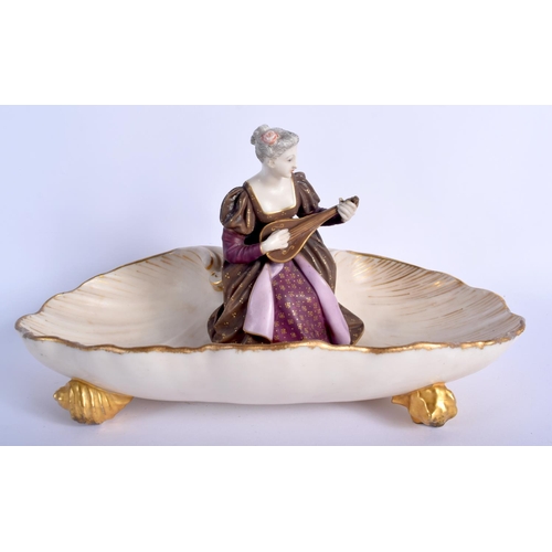 212 - Royal Worcester rare shell dish with four shell feet having a girl seated in the centre playing an i... 
