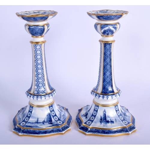 287 - Royal Crown Derby rare pair of blue and white candlesticks, the bases painted with sailing scenes by... 