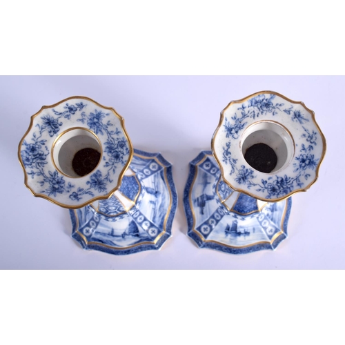 287 - Royal Crown Derby rare pair of blue and white candlesticks, the bases painted with sailing scenes by... 