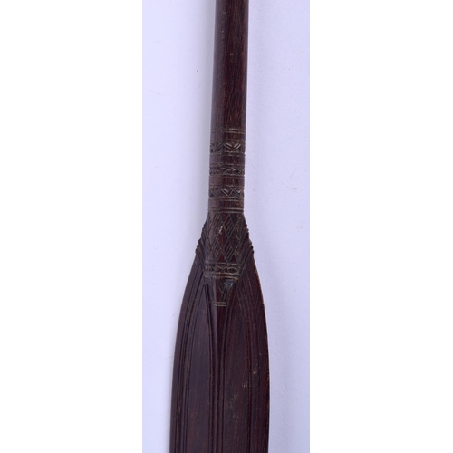 299 - AN AUSTRALIAN TRIBAL PADDLE together with a boomerang. Largest 50 cm long. (2)