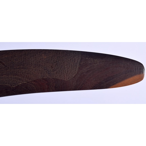 299 - AN AUSTRALIAN TRIBAL PADDLE together with a boomerang. Largest 50 cm long. (2)