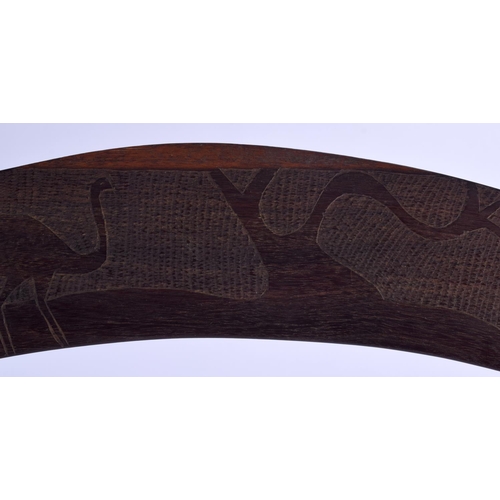 299 - AN AUSTRALIAN TRIBAL PADDLE together with a boomerang. Largest 50 cm long. (2)