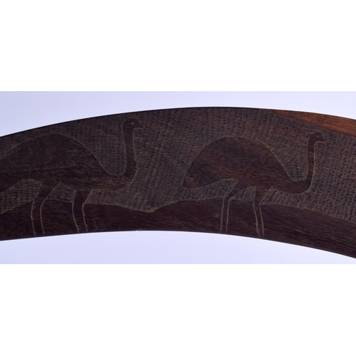 299 - AN AUSTRALIAN TRIBAL PADDLE together with a boomerang. Largest 50 cm long. (2)
