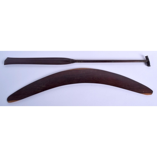 299 - AN AUSTRALIAN TRIBAL PADDLE together with a boomerang. Largest 50 cm long. (2)