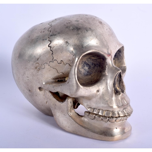 339 - A SILVER PLATED SKULL. 14 cm x 11 cm.