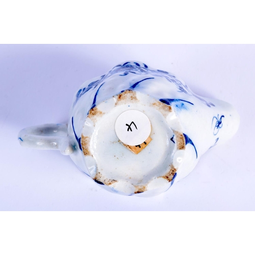 67 - AN 18TH CENTURY ENGLISH BLUE AND WHITE FLUTED CREAM BOAT Probably Derby, painted with floral sprays.... 