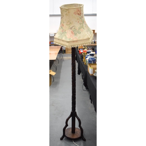 681 - A 19TH CENTURY CHINESE CARVED FLOOR LAMP, decorated with prunus and foliage. 200 cm