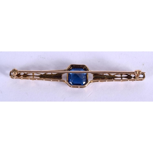 694 - A GOLD AND SAPPHIRE BAR BROOCH. 2.4 grams. 2.5 cm x 1 cm.