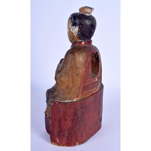 70 - AN 18TH CENTURY CHINESE POLYCHROMED WOOD TEMPLE FIGURE Ming style, modelled clutching an offering ve... 