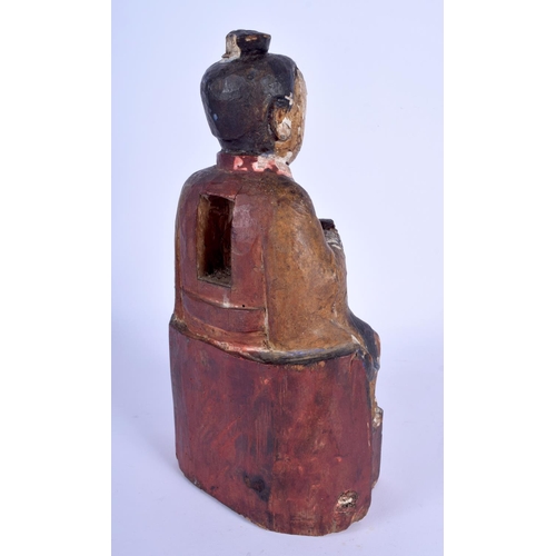 70 - AN 18TH CENTURY CHINESE POLYCHROMED WOOD TEMPLE FIGURE Ming style, modelled clutching an offering ve... 