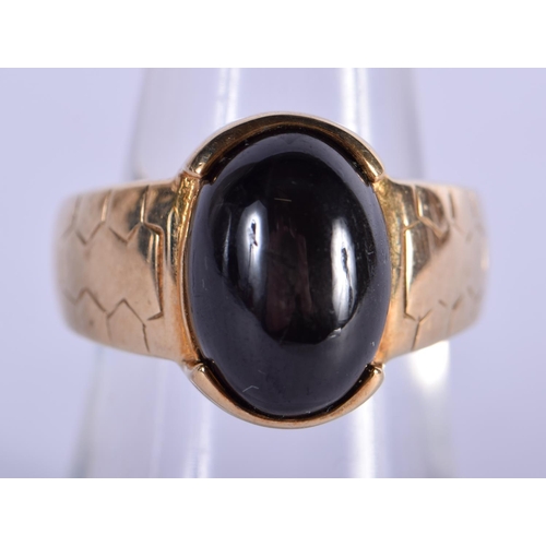 706 - A 9CT GOLD AND BLACK STONE RING. 7.6 grams. N.