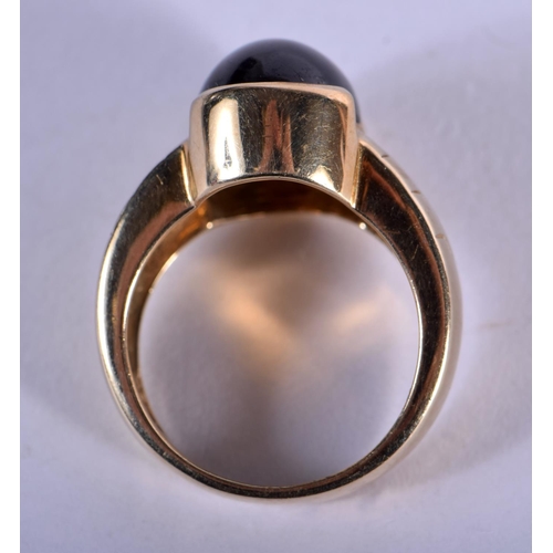 706 - A 9CT GOLD AND BLACK STONE RING. 7.6 grams. N.