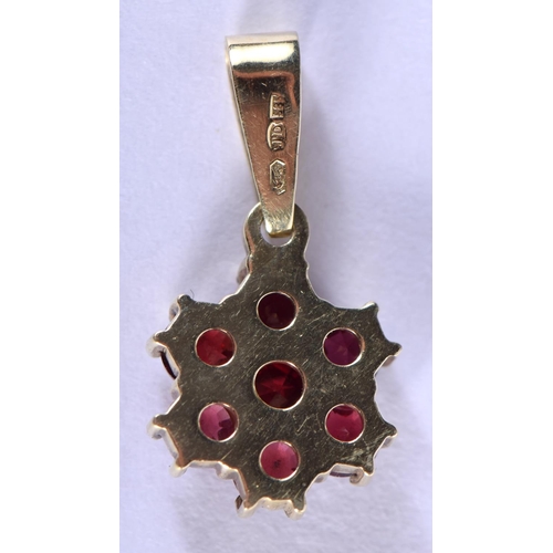 712 - A 14CT GOLD AND GARNET PENDANT. 1.5 grams. 2 cm x 1 cm.