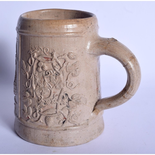 74 - AN EARLY RHINELAND STONEWARE SALT GLAZED TANKARD probably 17th/18th century, decorated with a trader... 
