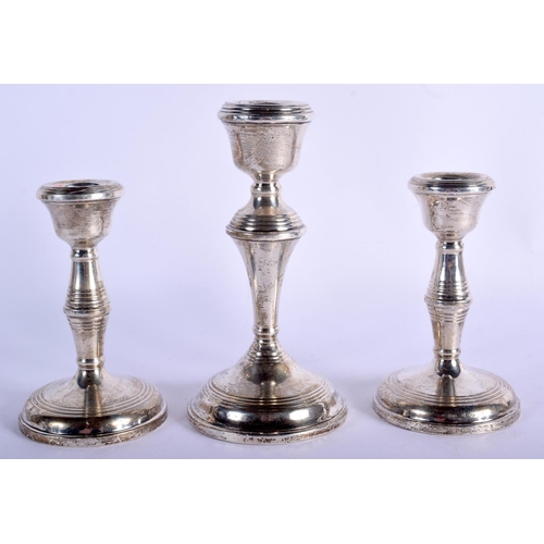 846 - THREE SILVER CANDLESTICKS. 450 grams overall. Largest 15 cm high. (3)