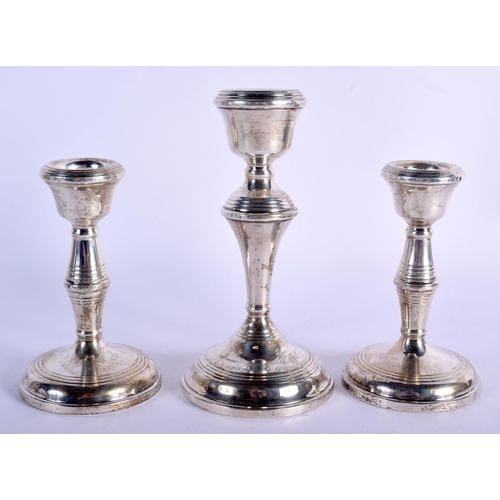 846 - THREE SILVER CANDLESTICKS. 450 grams overall. Largest 15 cm high. (3)