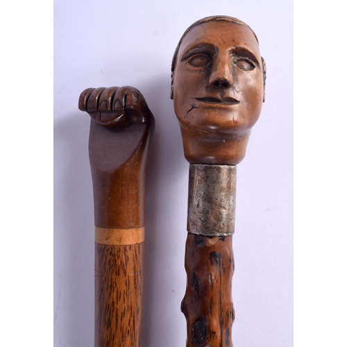 866 - AN 18TH/19TH CENTURY CARVED FRUITWOOD WALKING CANE together with a similar later fist cane. Largest ... 