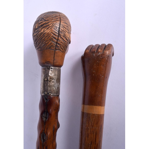 866 - AN 18TH/19TH CENTURY CARVED FRUITWOOD WALKING CANE together with a similar later fist cane. Largest ... 