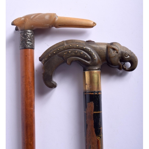 869 - TWO 19TH CENTURY MIDDLE EASTERN CARVED RHINOCEROS HORN WALKING CANES with animal head terminals. Lar... 