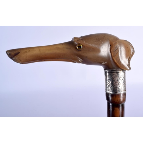 872 - AN ANTIQUE CARVED RHINOCEROS HORN SILVER MOUNTED WALKING CANE with bamboo type shaft. 86 cm long.