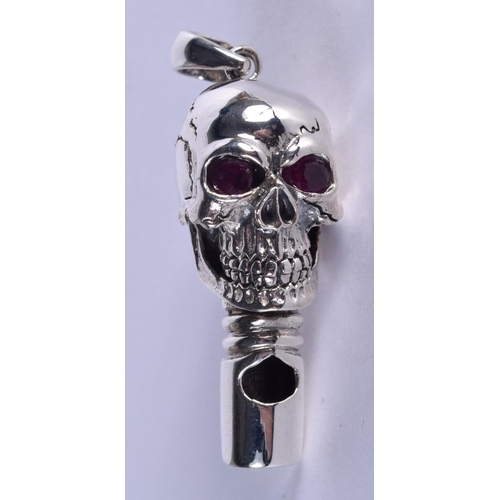 884 - A SILVER AND RUBY SKULL WHISTLE. 17 grams. 5 cm x 1.5 cm.