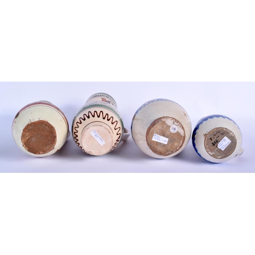 90 - FOUR EASTERN EUROPEAN TIN GLAZED POTTERY JUGS in various forms and sizes. Largest 25 cm high. (4)