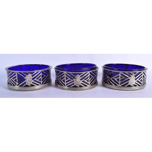 900 - A SET OF THREE GEORGE III IRISH COASTERS WITH BLUE GLASS LINERS.  14.5cm diameter, 5.8cm high (34)