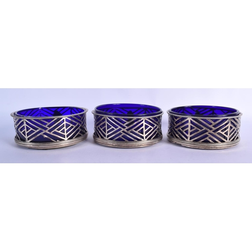 900 - A SET OF THREE GEORGE III IRISH COASTERS WITH BLUE GLASS LINERS.  14.5cm diameter, 5.8cm high (34)