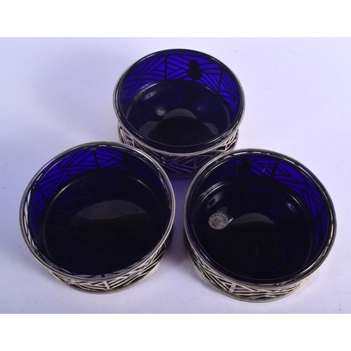 900 - A SET OF THREE GEORGE III IRISH COASTERS WITH BLUE GLASS LINERS.  14.5cm diameter, 5.8cm high (34)