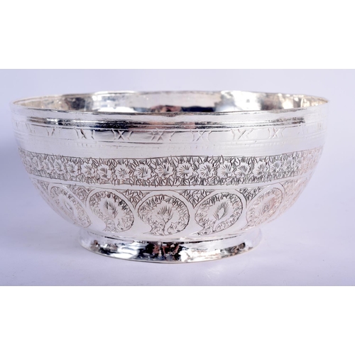 902 - AN INDIAN WHITE METAL BOWL WITH EMBOSSED DECORATION.  7.5cm diameter, 17cm high, weight 468g