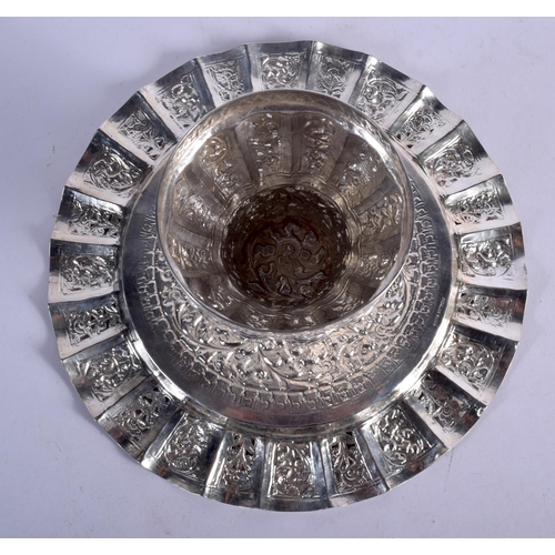 905 - AN INDIAN SILVER HEAVILY EMBOSSED TAZZA.  19.5cm diameter, 8cm high, weight 263g