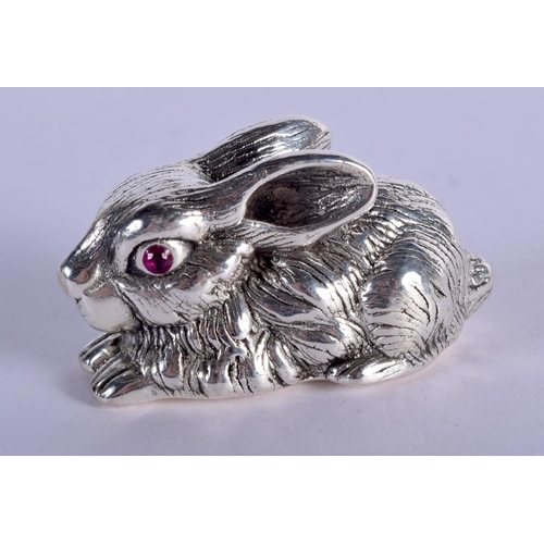 916 - A STERLING SILVER RABBIT WITH GEM SET EYES.  2.9cm x 5.5cm x 2.6cm, weight 27.6g