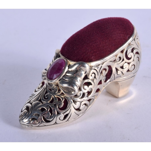 919 - A SILVER PLATED PIN CUSHION IN THE FORM OF A SHOE WITH A GEM INSET.  5.1cm x 2.8cm, weight 19.7g