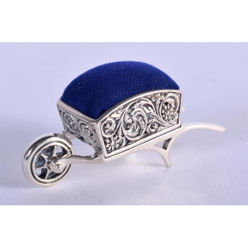 922 - A STERLING SILVER PIN CUSHION IN THE FORM OF A WHEELBARROW.  4.9cm x 2.4cm, weight 16.3g