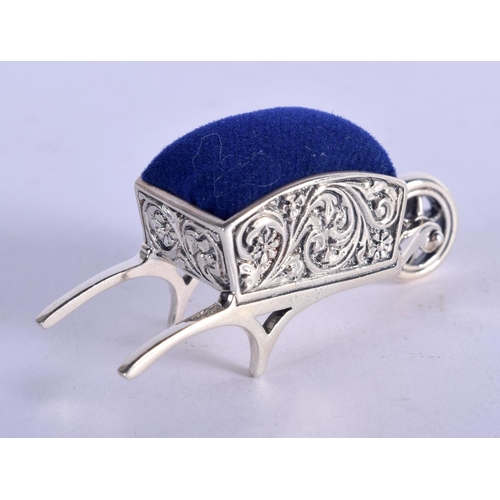 922 - A STERLING SILVER PIN CUSHION IN THE FORM OF A WHEELBARROW.  4.9cm x 2.4cm, weight 16.3g