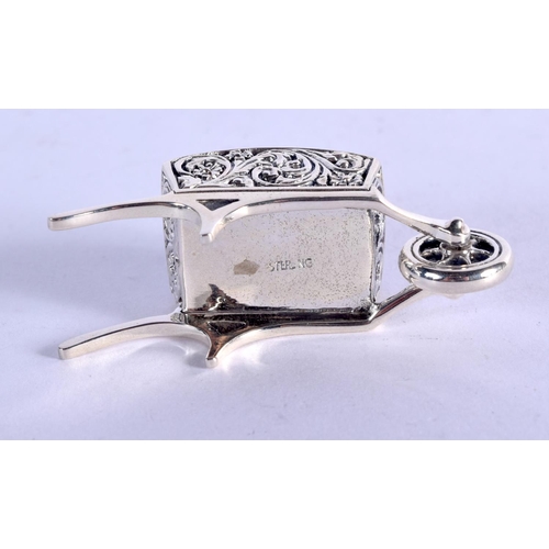 922 - A STERLING SILVER PIN CUSHION IN THE FORM OF A WHEELBARROW.  4.9cm x 2.4cm, weight 16.3g