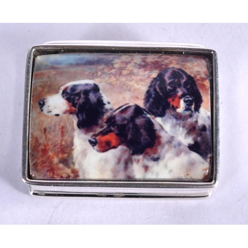 929 - A STERLING SILVER AND ENAMEL PILL BOX DECORATED WITH SPANIELS.  3.1cm x 2.5cm, weight 19.1g