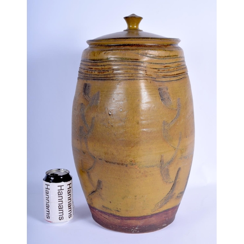 93 - A LARGE VINTAGE STUDIO POTTERY STONEWARE VASE AND COVER with scrafito decoration. 47 cm x 20 cm.