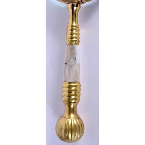 934 - A GILT AND MOTHER OF PEARL HANDLED MAGNIFYING GLASS.  10.5cm diameter, 25.5cm long