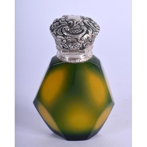 939 - A SILVER TOPPED GLASS SCENT BOTTLE.  7.4cm x .7cm. Weight 81g