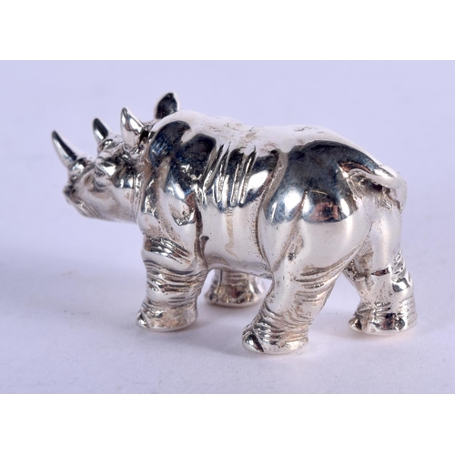 943 - A STERLING SILVER RHINO.  Stamped Sterling, 3.8cm x 1.9cm, weight 19.3g