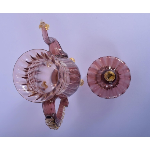 32 - AN EARLY 20TH CENTRY ITALIAN VENETIAN AUBERGINE GLASS EWER AND COVER upon a matching stand. 28 cm x ... 