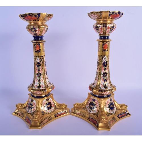 5 - A PAIR OF ROYAL CROWN DERBY IMARI PORCELAIN CANDLESTICKS painted with flowers and vines. 28 cm high.